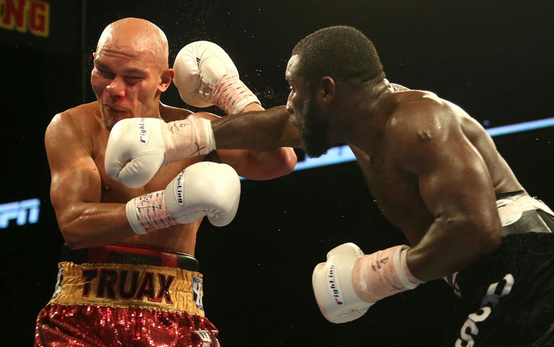 Ossie Duran aka - The Ghanaian Gladiator landed a right hook to the jaw of USBA Middleweight Champion Caleb Truax, of Osseo, Minnesotaduring a semi final fight at Target Center in Minneapolis Friday, January 3, 2014. The bout ended in a tie 95-95. ] (KYNDELL HARKNESS/STAR TRIBUNE) kyndell.harkness@startribune.com
