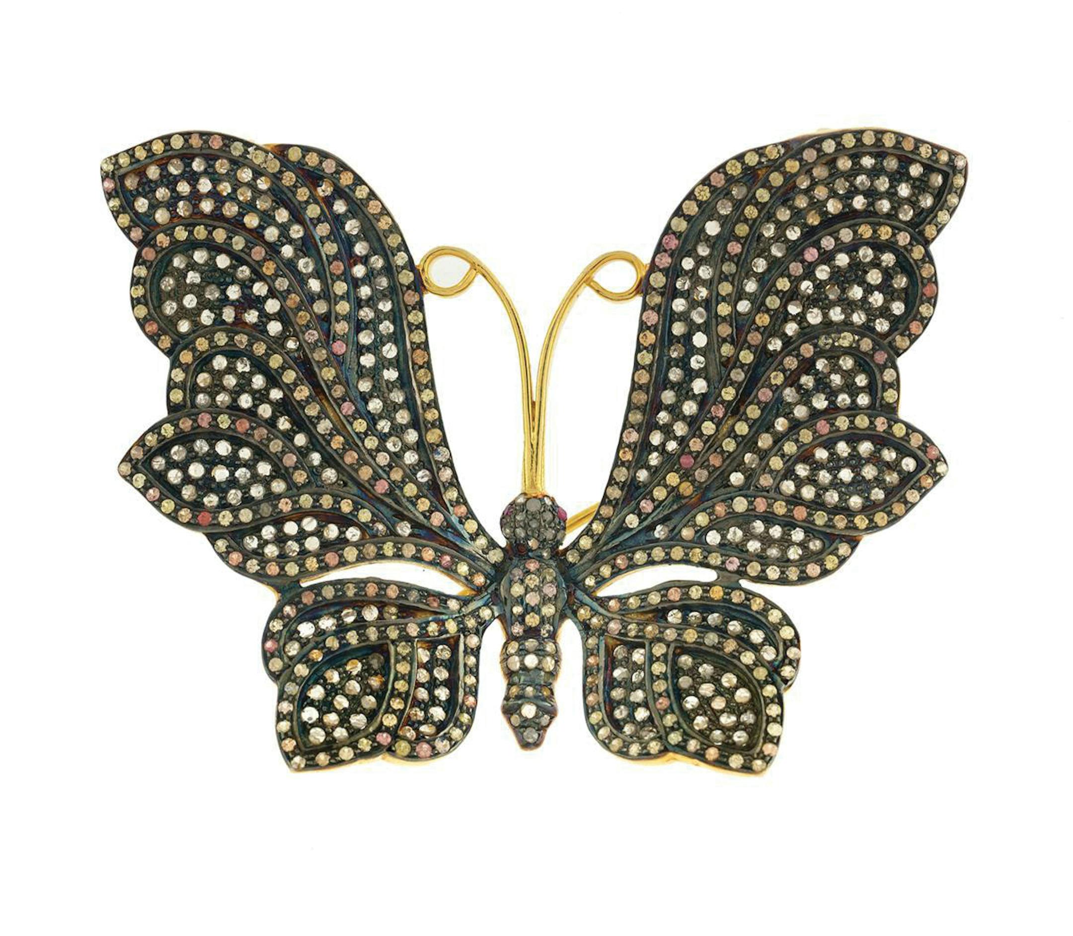 You won't see a butterfly like this one in your garden! This butterfly-shaped pin sparkles with multicolored sapphires and antique-cut diamonds. Cowles Syndicate