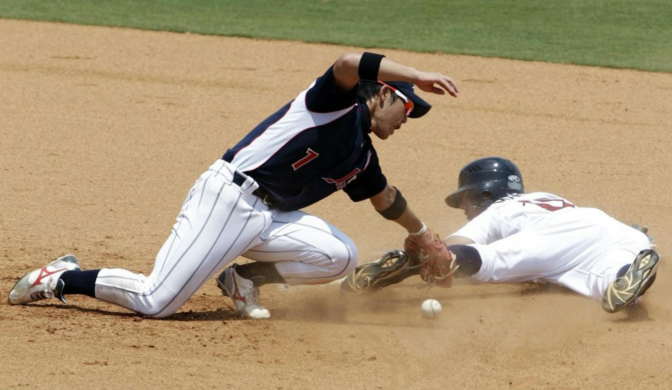 Japan's Daichi Suzuki (1) bobbles the throw, as USA's Deven Marrero (17) is safe in the 7th inning during game one of a double header. USA Baseball's Collegiate National Team beat Japan's college all-stars, 8-2 at the USA Baseball National Training Complex in Cary North Carolina, on Tuesday, July 5, 2011.