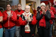 Members of the St. Paul Federation of Educators bargaining team, including Rene Myers, center, and Davia Christiansen, right, celebrate a new agreemen
