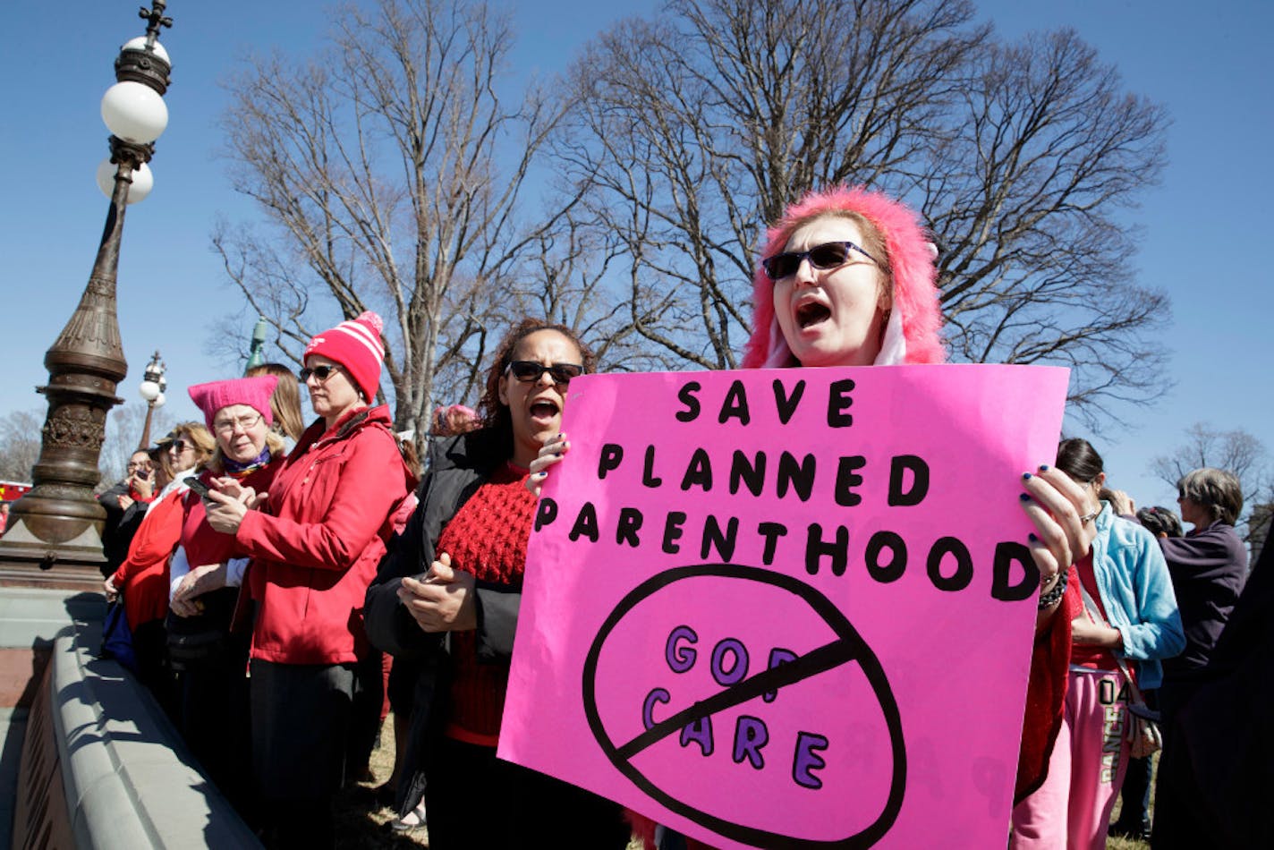 An activist protests cutting funds for Planned Parenthood in March in Washington, D.C.