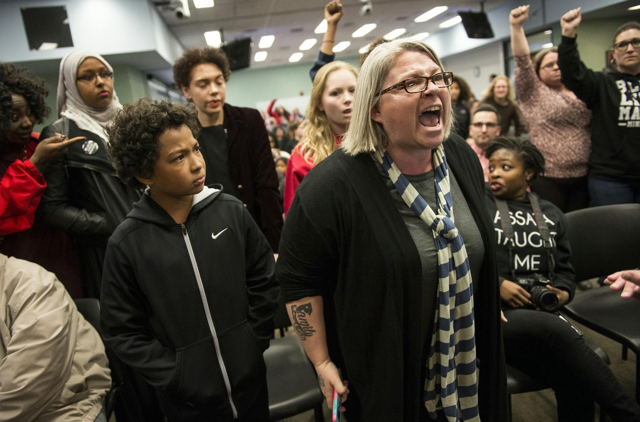 Susan Montgomery and her 11-year-old son, Taye Clinton, left, interrupted the St. Paul School Board meeting Tuesday night during a demonstration.