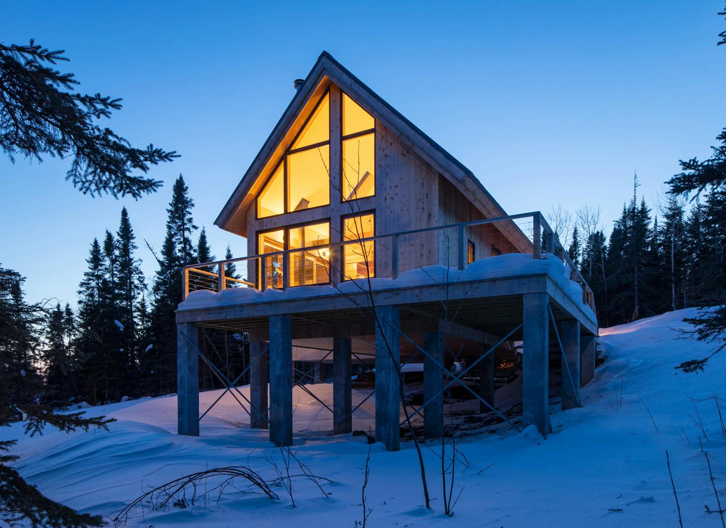 The cabin's large windows bring the outdoors in.