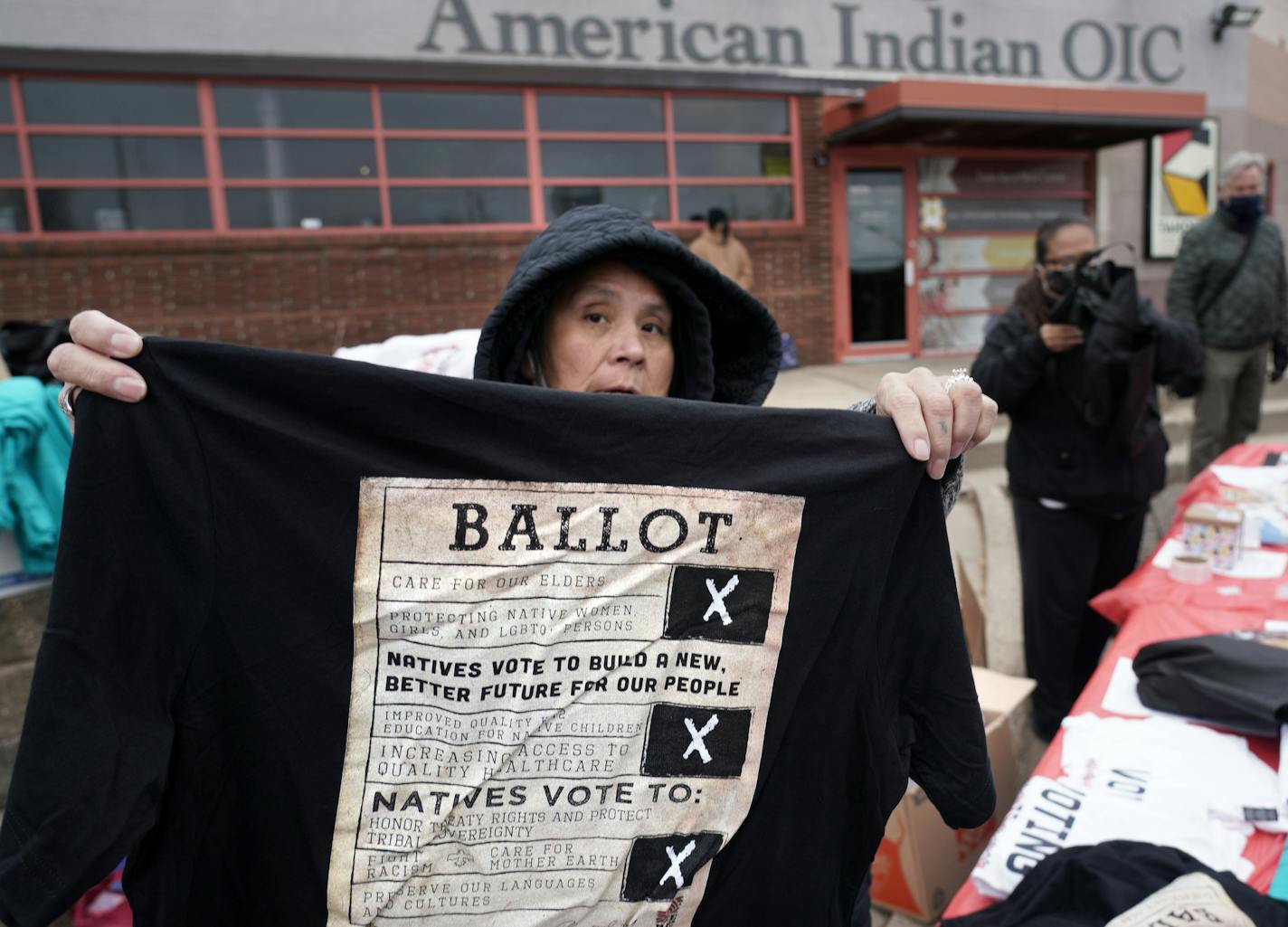 Maggie Thunder-Hawk distributed T-shirts at the get-out-the-vote event at American Indian OIC in Minneapolis on Thursday.