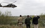 President Donald Trump salutes as he tours the U.S. border with Mexico at the Rio Grande on the southern border, Thursday, Jan. 10, 2019, in McAllen, 