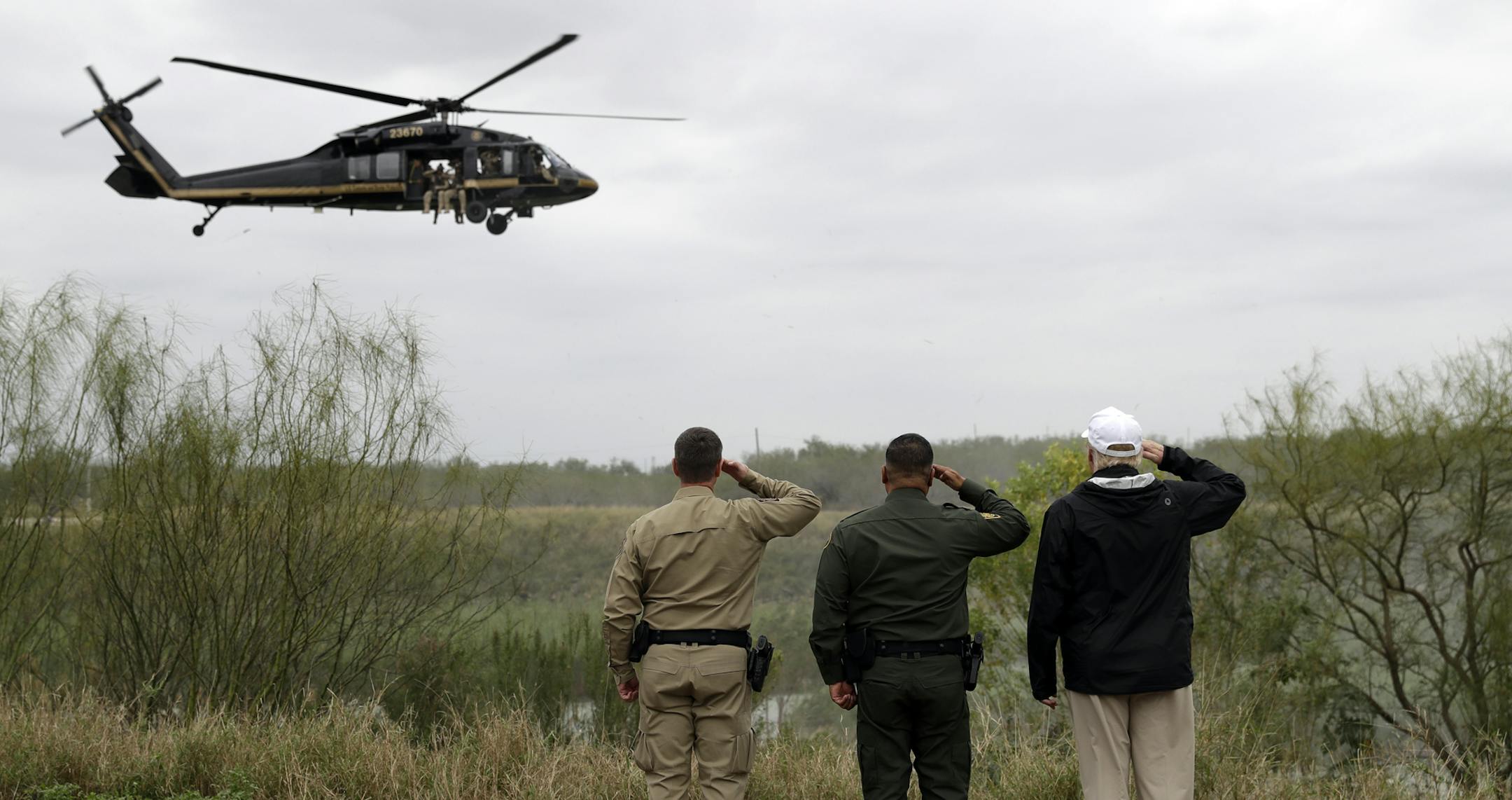 President Donald Trump salutes as he tours the U.S. border with Mexico at the Rio Grande on the southern border, Thursday, Jan. 10, 2019, in McAllen, Texas. (AP Photo/ Evan Vucci)