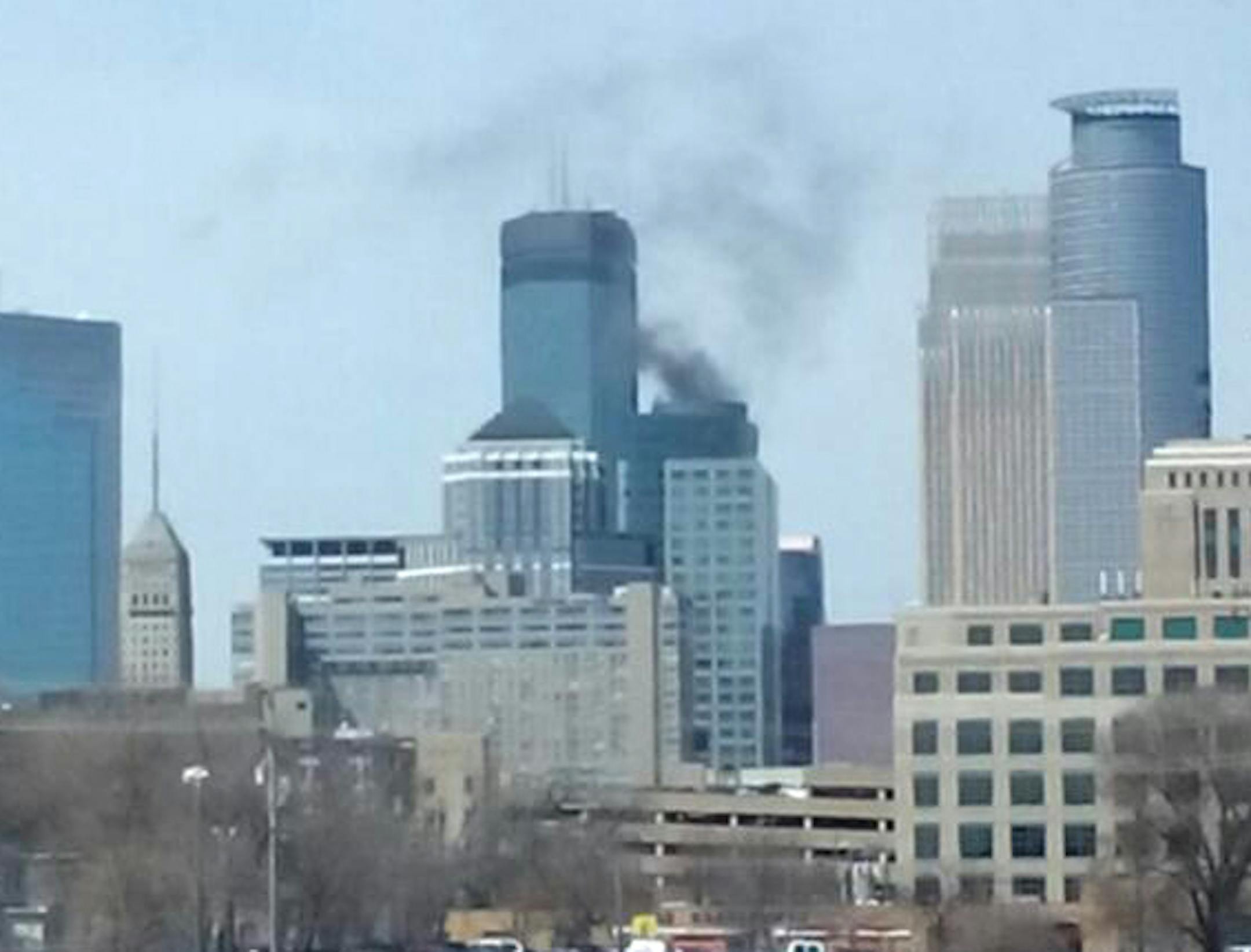 Black smoke is seen rising from the top of the Ameriprise building Tuesday afternoon, Apr. 22, 2014.