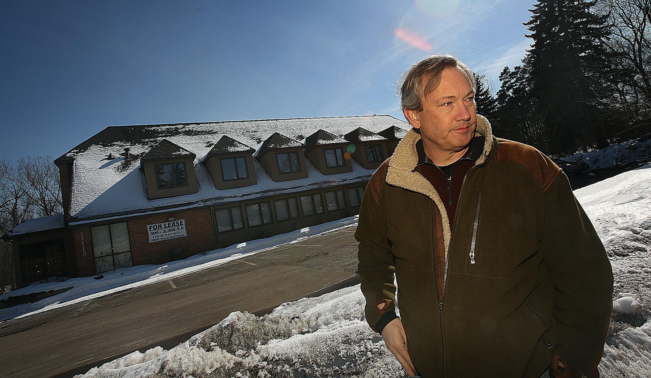 Scott Colehour lives near the site of a proposed senior apartment complex. The site is presently occupied by a smaller building that houses some offices (behind).