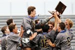 Prior Lake celebrates after winning the boys' lacrosse state championships.