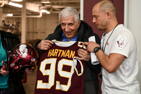Minnesota Golden Gophers head coach P.J. Fleck gave Sid Hartman a custom jersey and helmet for his 99th birthday in 2019.