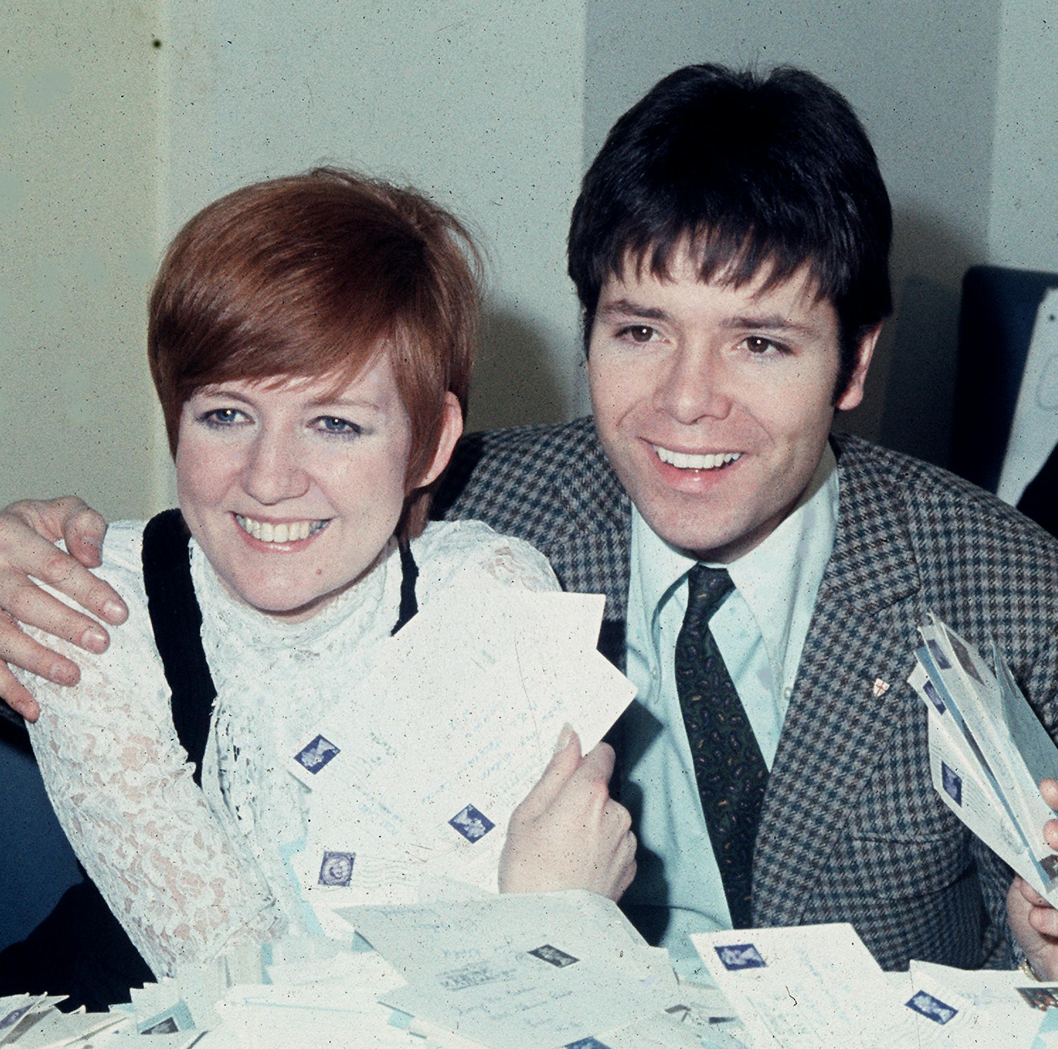 FILE - In this March 8, 1968 file photo, singer Cilla Black counts votes with singer Cliff Richard for Britain's "Song For Europe", in Shepherd's Bush, London. Spanish police said Sunday that the singer, who had a home in Estepona, southern Spain, died Saturday, Aug. 1, 2015. Born Priscilla White, Black worked as a teenager in the cloakroom of Liverpool’s Cavern Club, where her musical talent was spotted by The Beatles. (AP Photo, File)