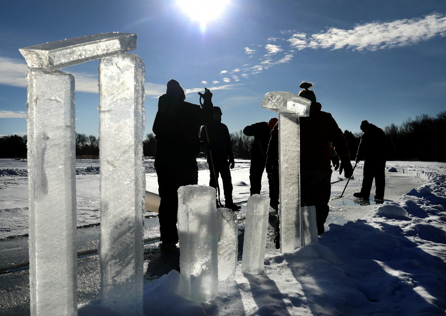 Chuck Zwilling and his crew worked on cutting the ice for their giant floating ice carousel -- more than 130 meters across -- on Green Prairie Fish Lake, using a custom rig that combines tracks from a snowblower and two chainsaws Thursday, Jan. 10, 2019, in Little Falls, MN. Here, ice chunks pulled from the lake line the carousel as workers pull out more ice.