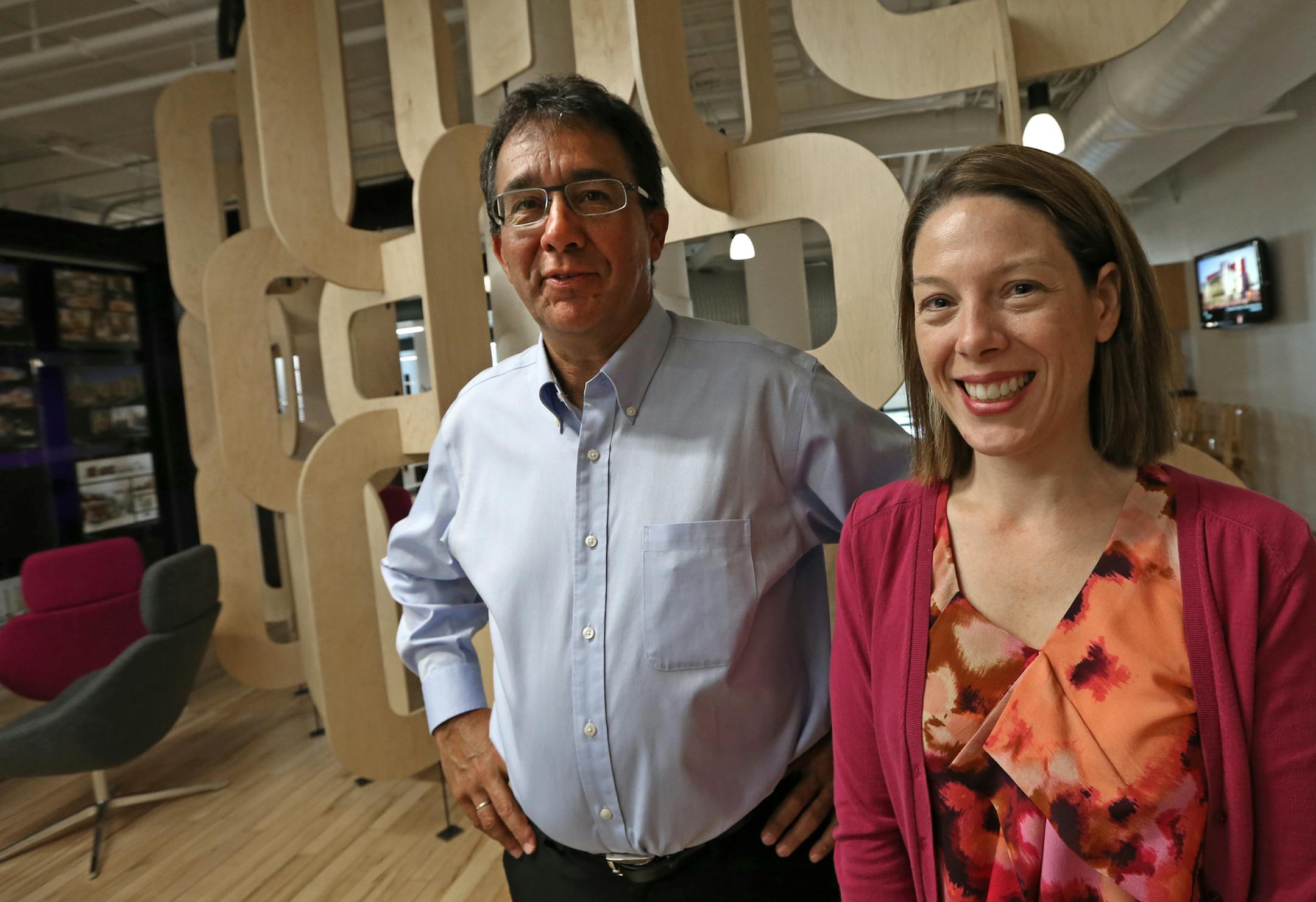(left to right) LHB Architects Rick Carter, commercial focus leader and Elizabeth Tomlinson, mechanical senior engineer were photographed at the LHB offices in downtown Minneapolis on 7/17/14. Several years ago LHB Architects launched its Regional Indicators Initiative, which tracks data about energy consumption for dozens of Twin Cities municipalities. The project helped the company nagivate its way through the economic downturn, and recent tweaks to the program have helped drive the company's