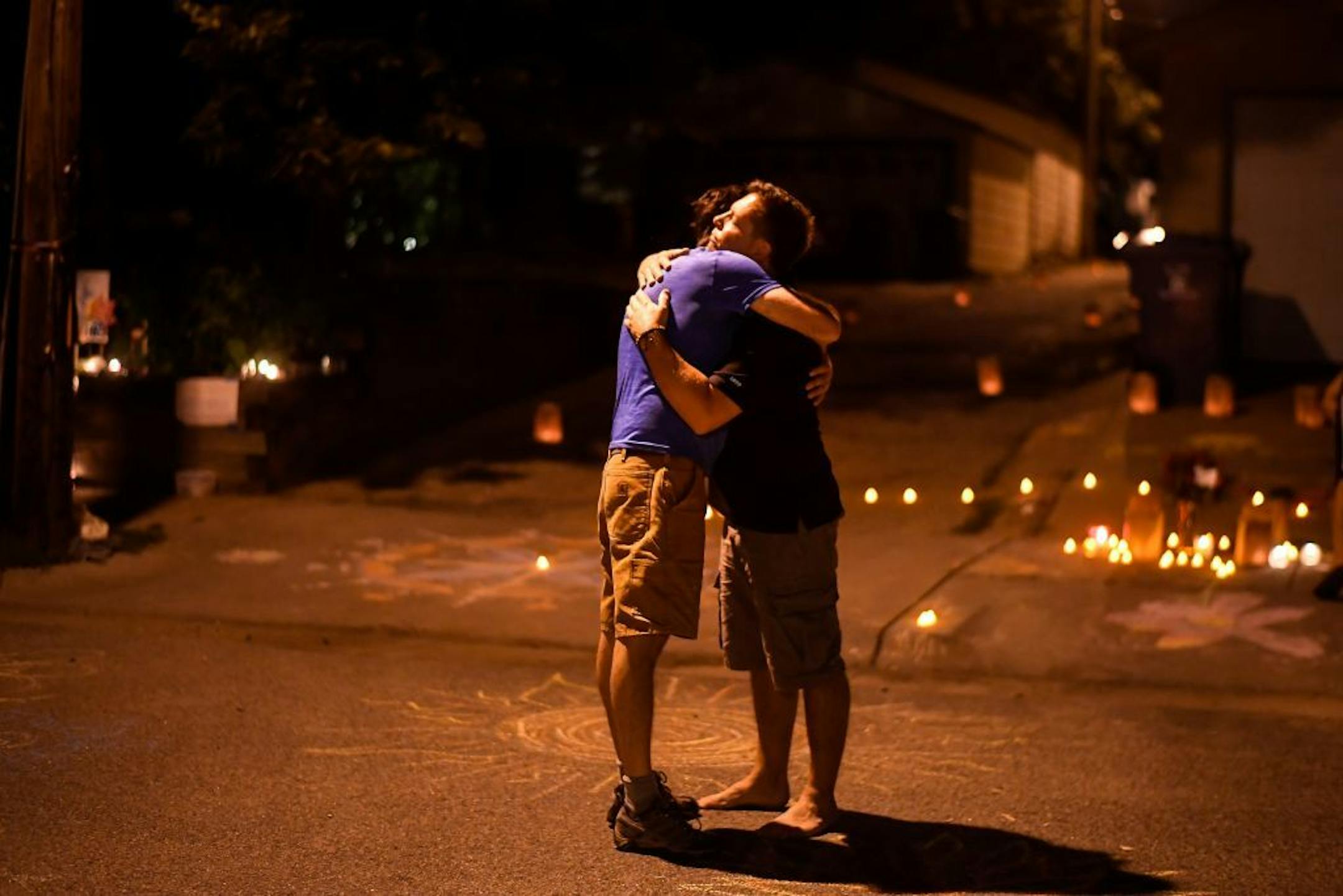 Don Damond shared an embrace with friend and neighbor John Barry during a candlelight vigil for Justine Damond Ruszczyk.
