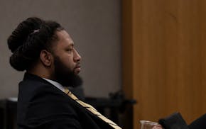 Derrick Thompson listens to testimony from Minneapolis Police Sgt. David Ligneel during Thompson's trial Wednesday in Minneapolis.