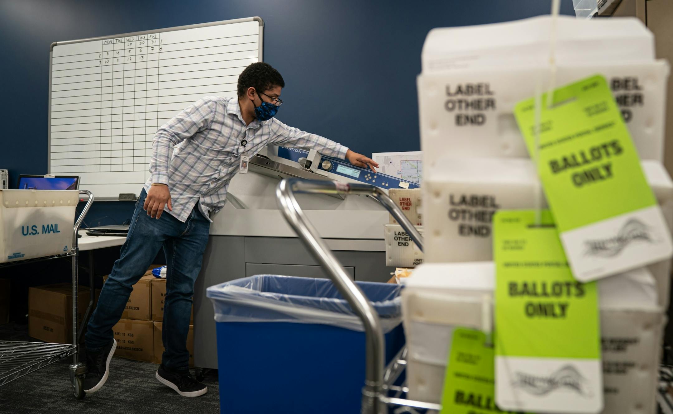Elections administrator Jon Martin ran newly received ballots through a machine that opens them and stamps the date they were received. The old machine at Minneapolis Elections & Voter Services could process 400 each hour. This new machine, received in May, can process 40,000 in the same amount of time.