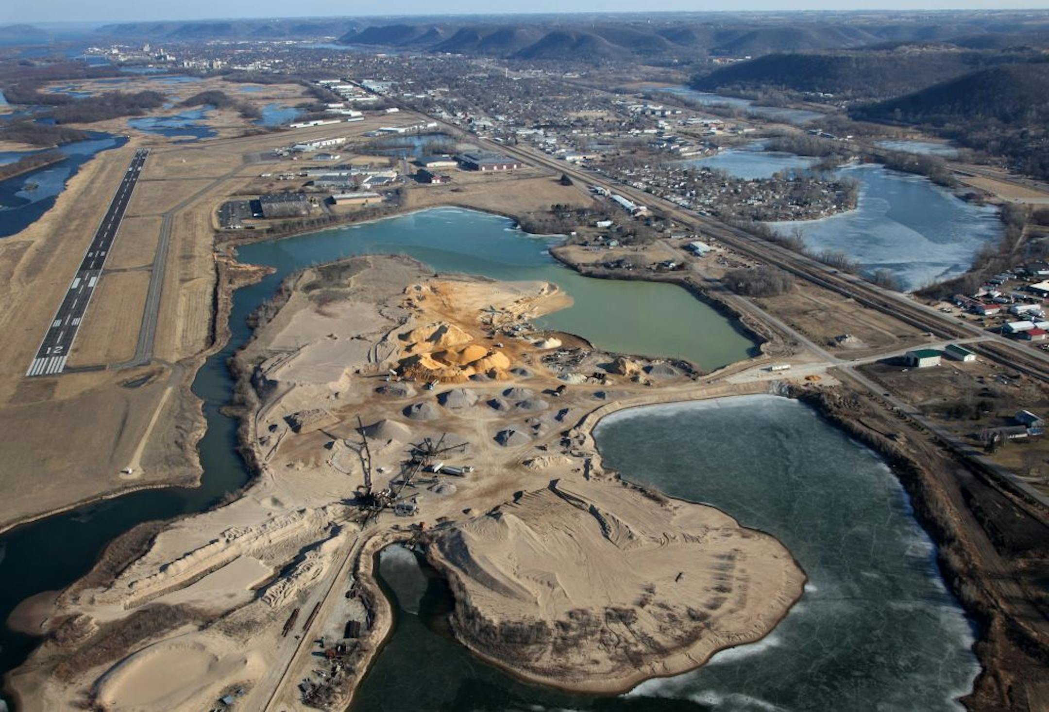 Nowhere are the concerns about sand mining, and expectations for its economic potential, more palpable than in the town of Winona. It's also becoming a lesson in how communities cope with a new industry that is booming in lock step with the business it supplies – the controversial oil and gas drilling practice called hydro fracking. (IN THIS PHOTO) Aerial views of the Sand processing area on the north end of town along the Mississippi River.