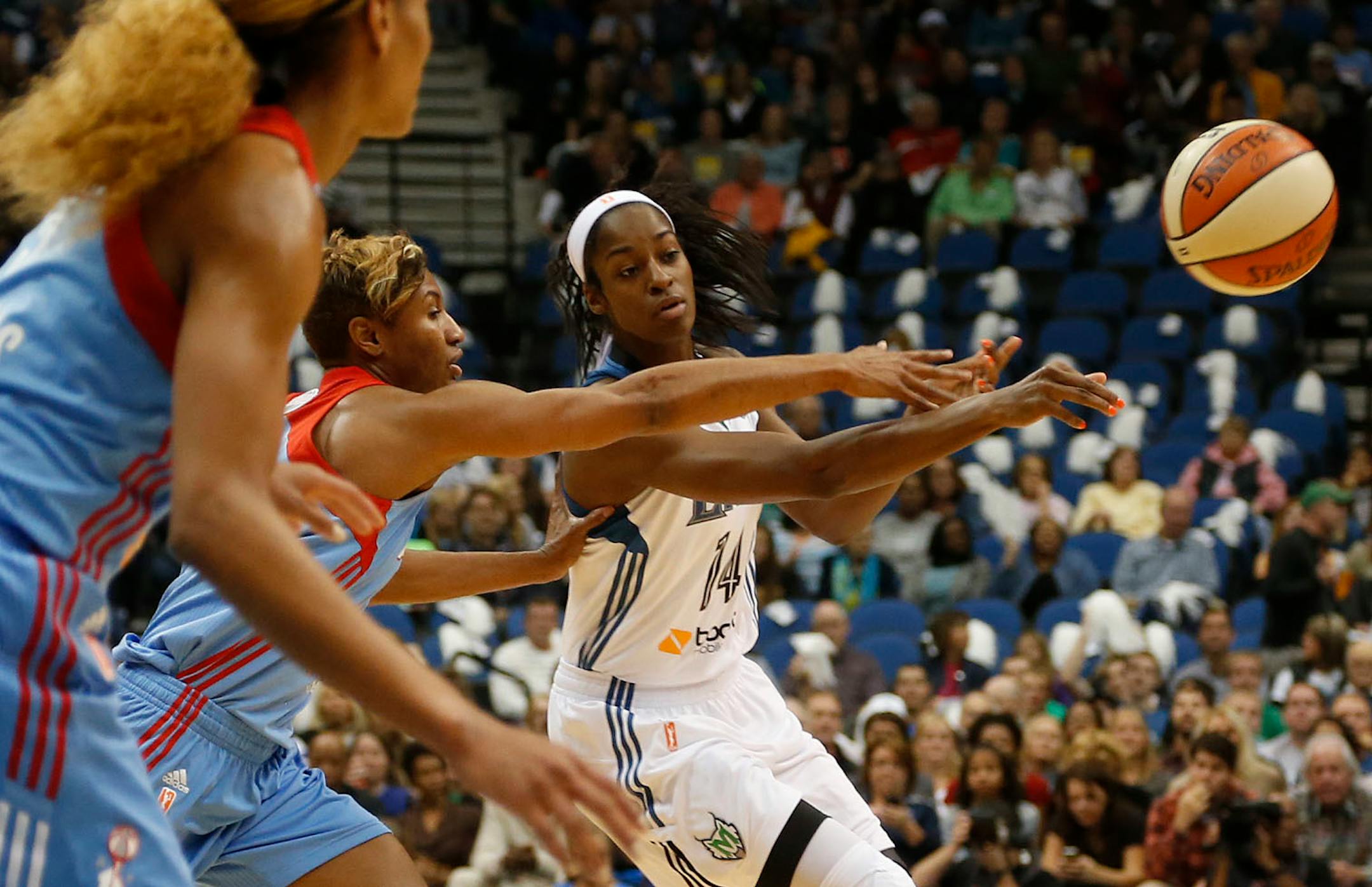 Devereaux Peters passed the ball to a teammate with the Dream's Angel McCoughtry defending during the first quarter of the WNBA Finals at the Target Center in Minneapolis, Min., Sunday, October 6, 2013.