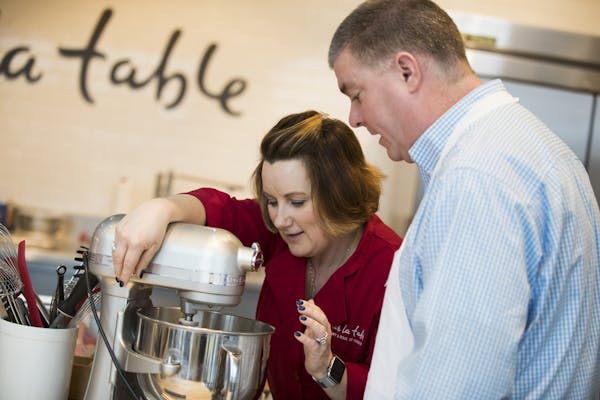 Crystal Boudreau, left, helps out Chip Scoggins with his mixer during class.
