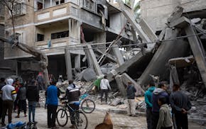 Palestinians inspect the damage of residential buildings after an Israeli airstrike in Rafah, southern Gaza Strip, Sunday, March 24, 2024. (AP Photo/F