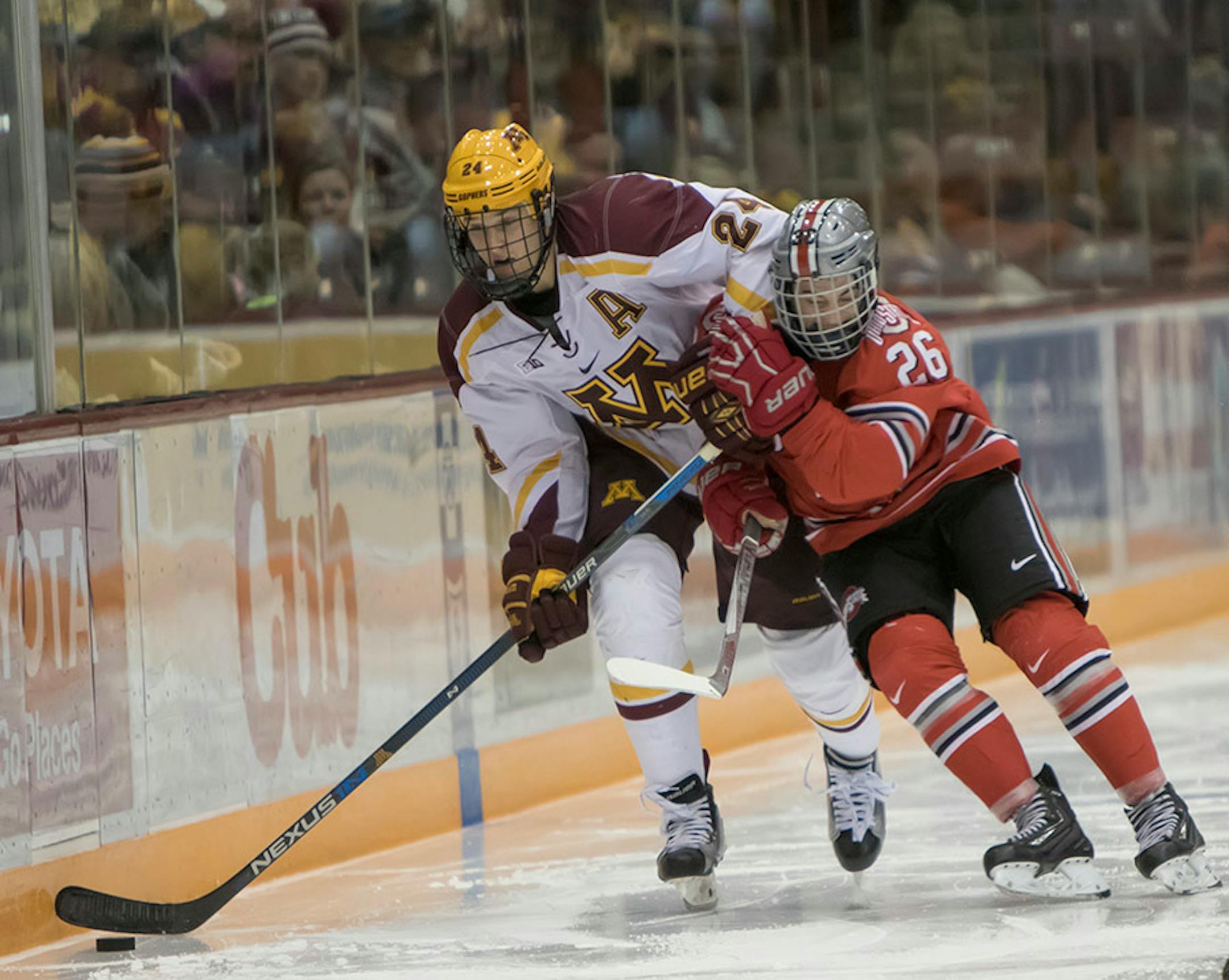 Minnesota Golden Gophers forward Hudson Fasching (24) is hit by Ohio State Buckeyes forward Mason Jobst (26) as the Minnesota Golden Gophers hosted the Ohio State Buckeyes to open the Big Ten Conference schedule on December 4, 2015. ] Special to Star Tribune MATT BLEWETT ï matt@mattebphoto.com - December 4, 2015, Minneapolis, MN, Big Ten Hockey, Minnesota Golden Gophers vs. Ohio State Buckeyes, 257622 UPUK 120415