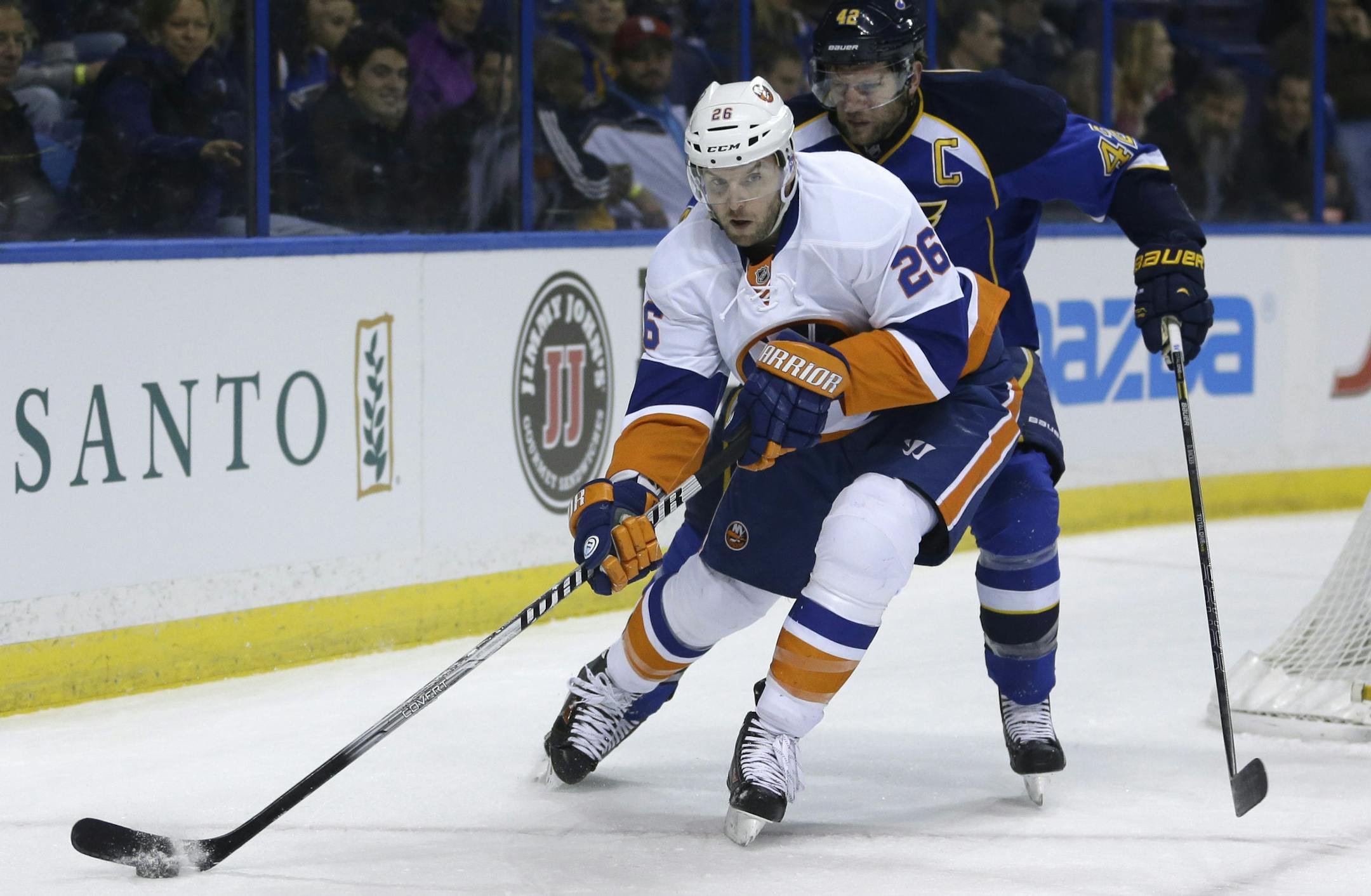 In this Dec. 5, 2013, photo, New York Islanders' Thomas Vanek, of Austria, looks to pass as St. Louis Blues' David Backes defends during an NHL hockey game in St. Louis. The Montreal Canadiens have acquired Vanek from the Islanders. Montreal sent forward prospect Sebastien Collberg, a 2014 second-round pick and a conditional fifth-rounder to the Islanders for Vanek on Wednesday, March 5, 2014. (AP Photo/Jeff Roberson)
