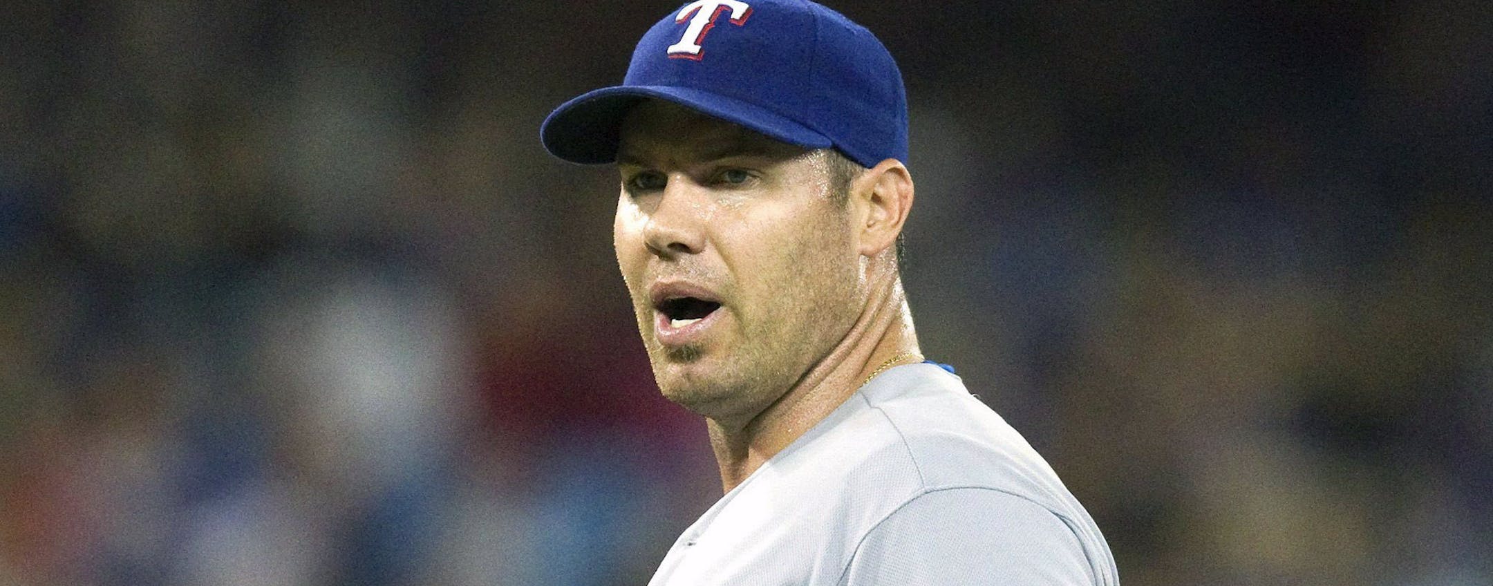 Texas Rangers starting pitcher Colby Lewis has words with Toronto Blue Jays Colby Rasmus (not shown) after Rasmus bunted his way on during the fifth inning of a baseball game, Saturday, July 19, 2014 in Toronto. (AP Photo/The Canadian Press, Fred Thornhill)