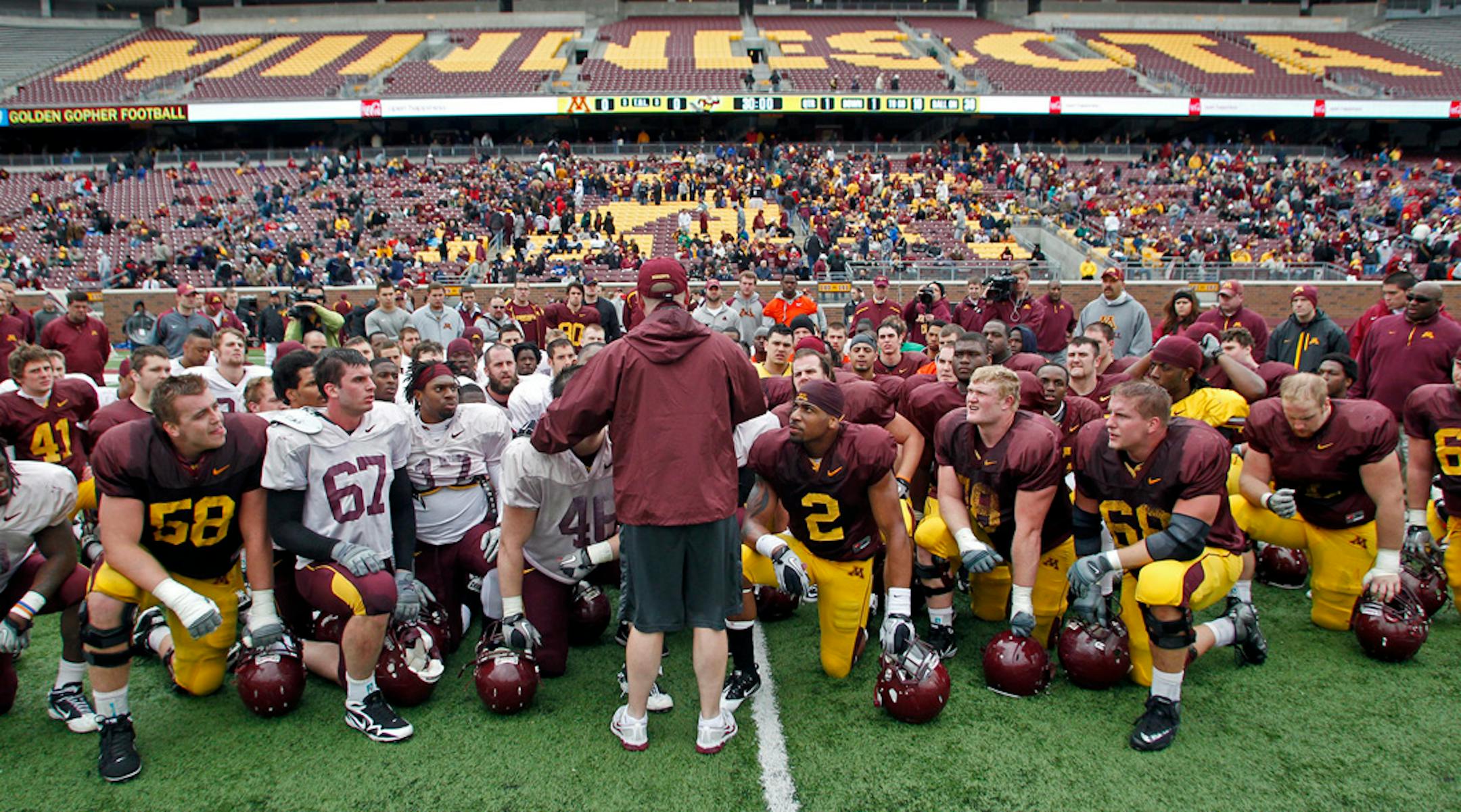 Head football coach Jerry Kill talked to his players at the end of the spring game at TCF Bank Stadium