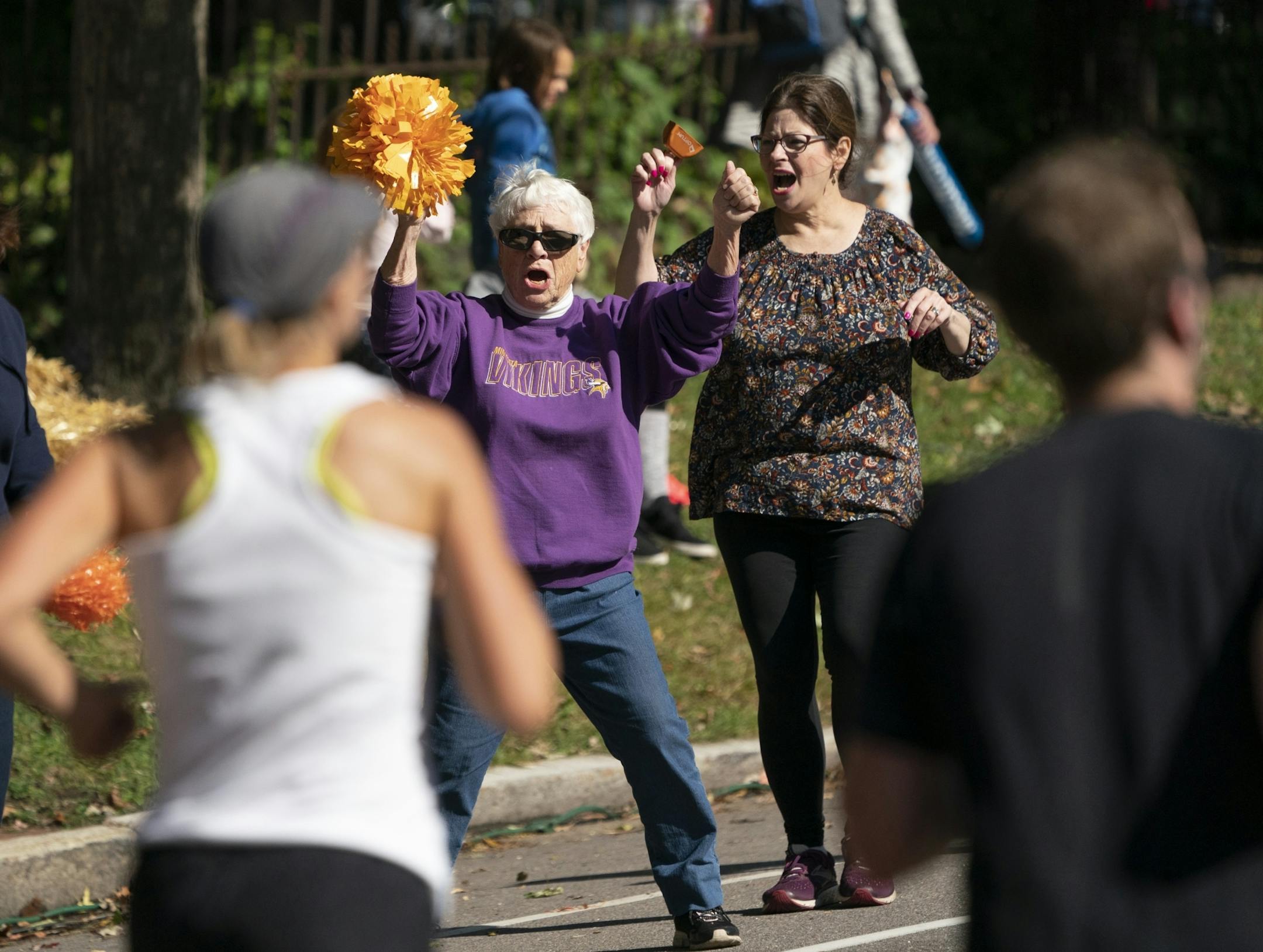 Jean Ford and Marianne Kipp enthusiastically danced on the side of the road near mile 26.