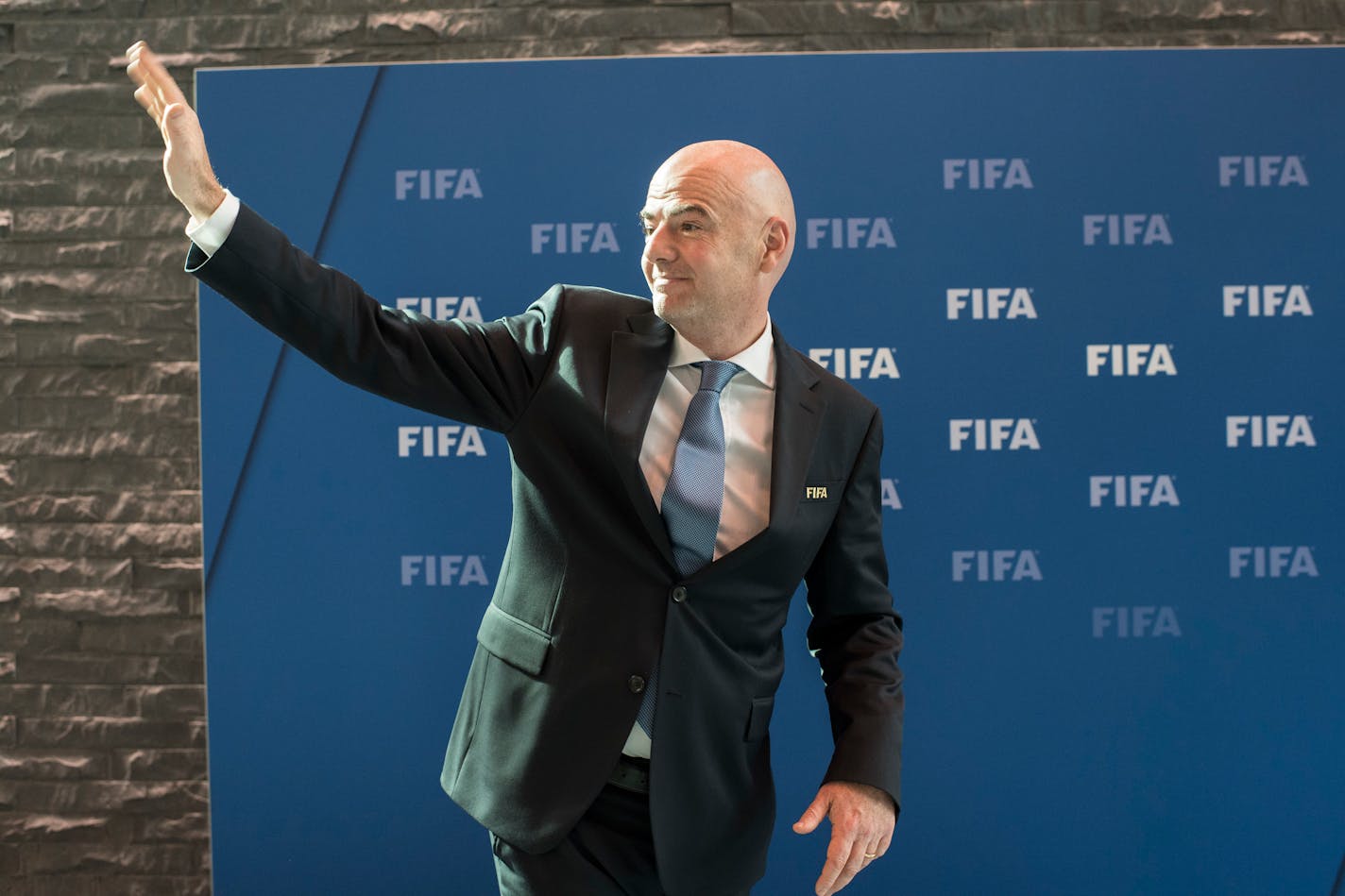 FIFA President Gianni Infantino waves during the press conference after the FIFA Council meeting at the Home of FIFA in Zurich, Switzerland, Friday, Oct. 14, 2016. (Ennio Leanza/Keystone via AP)