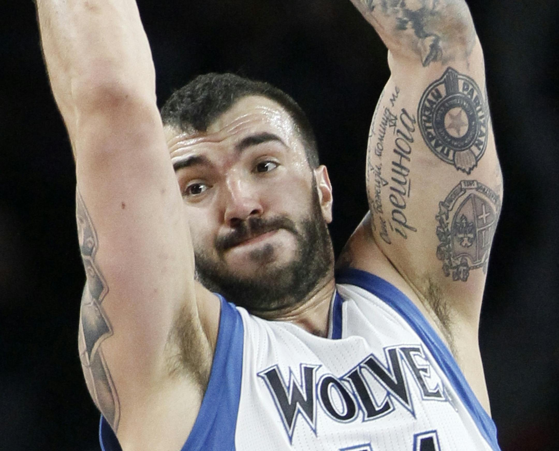Minnesota Timberwolves' Nikola Pekovic (14) grabs a defensive rebound in front of Detroit Pistons' Greg Monroe during the first half of an NBA basketball game, Sunday, Feb. 8, 2015, in Auburn Hills, Mich. The Timberwolves defeated the Pistons 112-101. (AP Photo/Duane Burleson)
