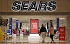 FILE - In this Wednesday, Feb. 8, 2017, file photo, shoppers walk into a Sears store in Pittsburgh. Sears said that there is "substantial doubt" that 