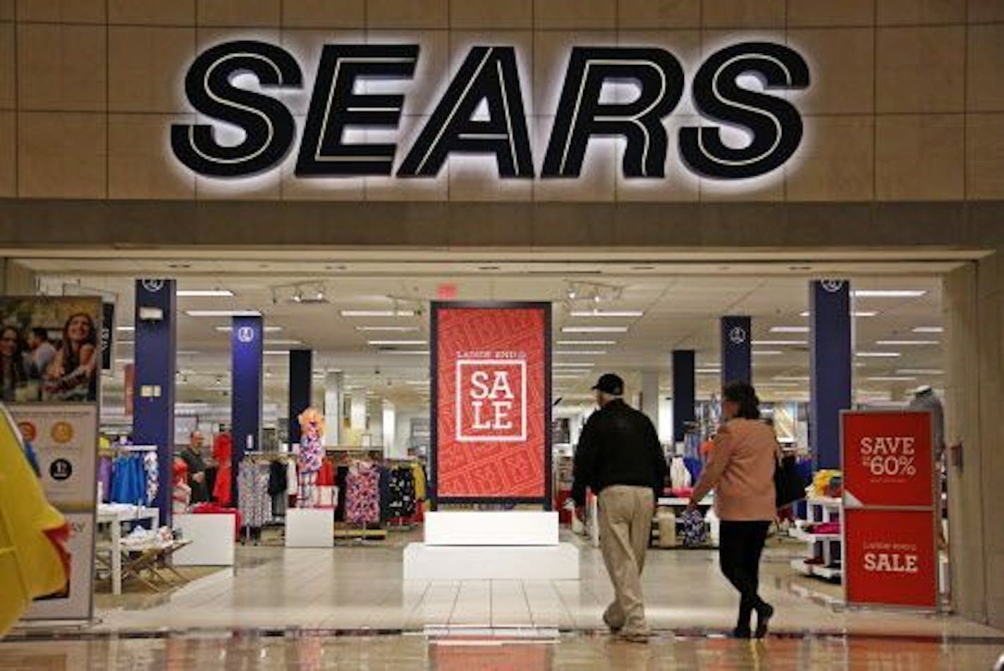 FILE - In this Wednesday, Feb. 8, 2017, file photo, shoppers walk into a Sears store in Pittsburgh. Sears said that there is "substantial doubt" that it will be able to remain in business.