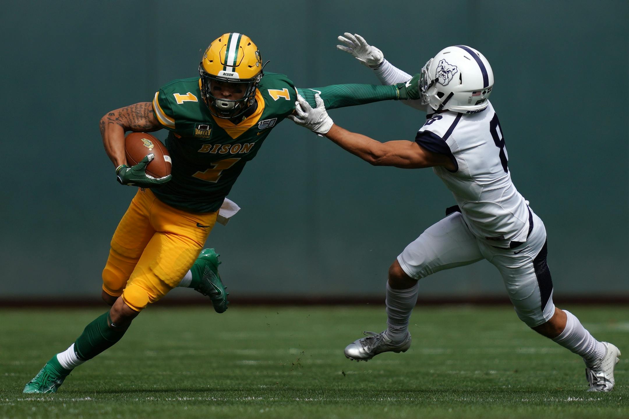 North Dakota State Bison wide receiver Christian Watson (1) avoided the tackle by Butler Bulldogs defensive back Devin Aguilar (8) in the first half.