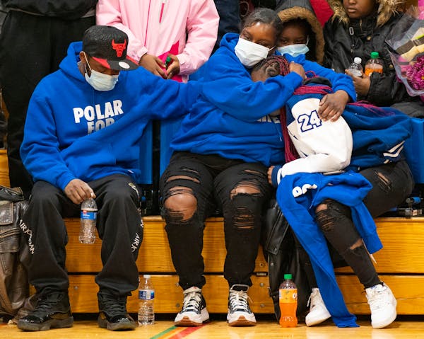 Deshaun Hill Sr. and Tuesday Sheppard, Deshaun Hill Jr.’s parents, comfort their daughter, Talina Hill, left to right, during the North Community Hi