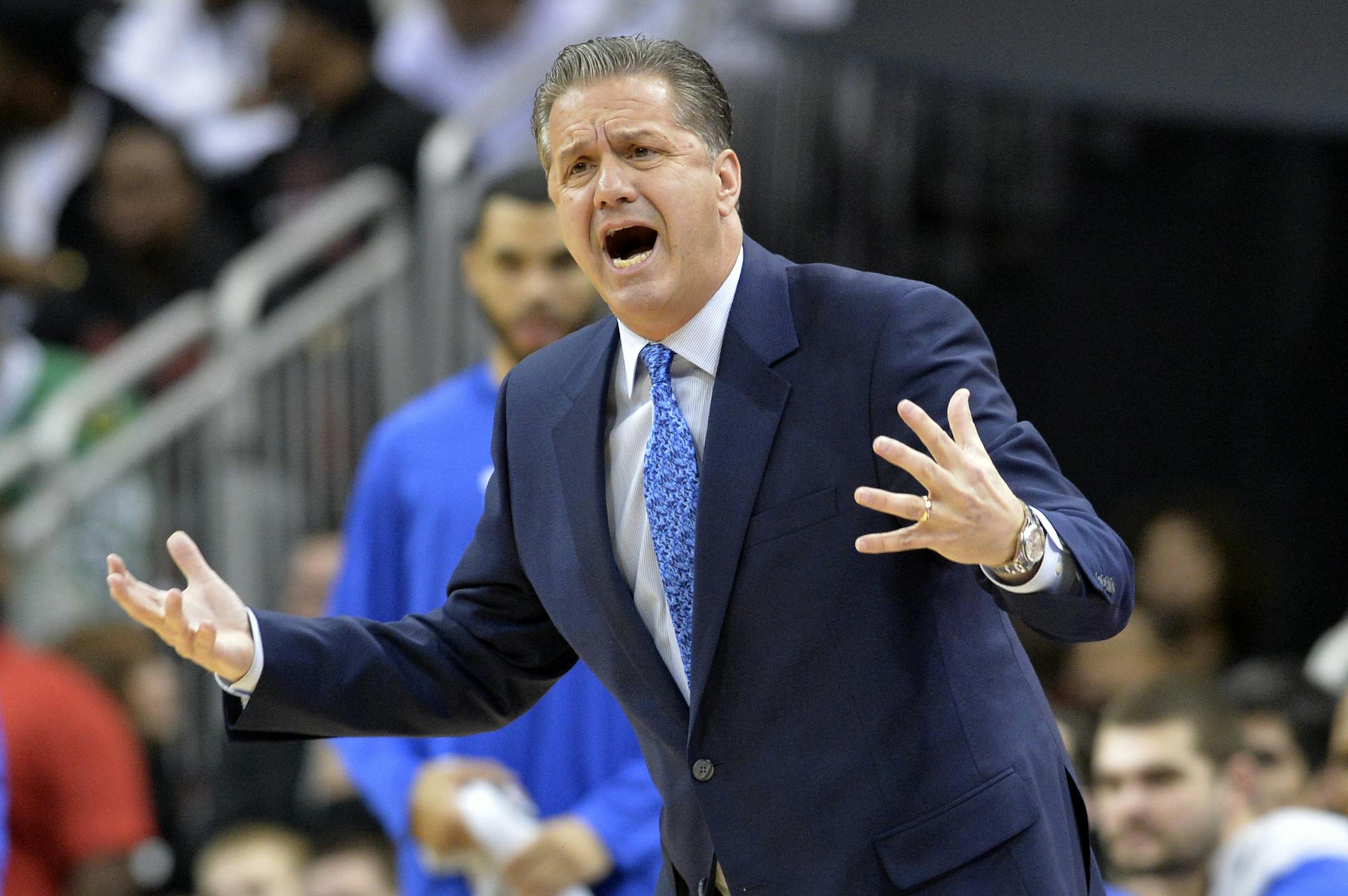 Kentucky's head coach John Calipari complains to a game official during the first half of an NCAA college basketball game against Louisville, Wednesday, Dec. 21, 2016, in Louisville, KY. (AP Photo/Timothy D. Easley)