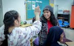 St. Paul Central High School special education teacher Elvira Efrida, right, who was born in Indonesia, is in the first year of a residency through a 
