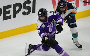 Minnesota Frost defender Natalie Buchbinder controls the puck against New York Sirens forward Elizabeth Giguere when the teams met April 27 at Xcel En