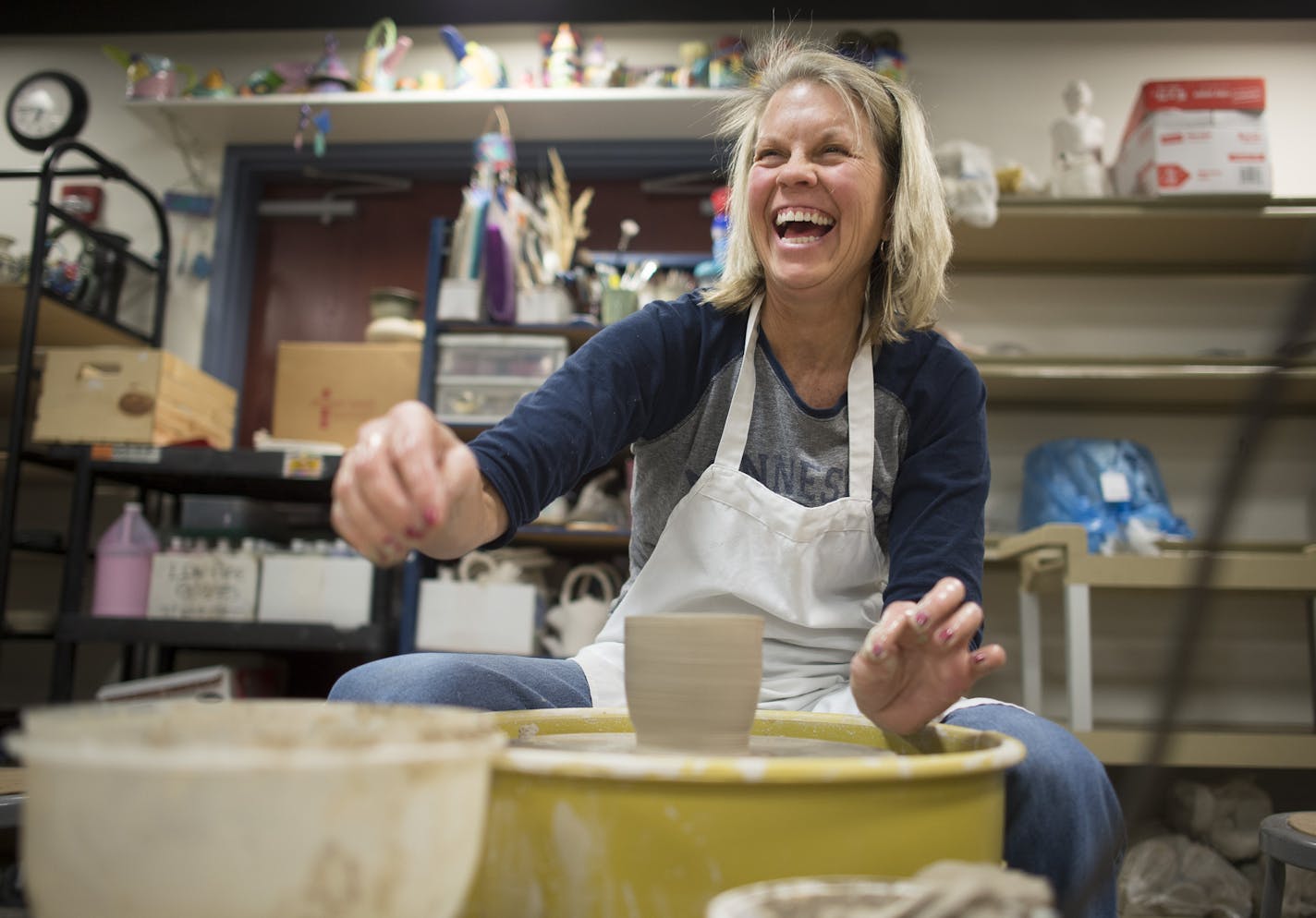 Madonna Denley, of Lakeville, enjoys spending her Thursday night throwing clay on a pottery wheel as part of a six week class at the Lakeville Area Arts center. ] (Aaron Lavinsky | StarTribune) Students at the Lakeville Area Arts Center take a pottery class under the tutelage of instructor JoAnne Andres on Friday, Jan. 9, 2015. The course is six weeks long and provides instruction and hands-on demonstration to students hoping to learn how to hand form and wheel throw pottery.