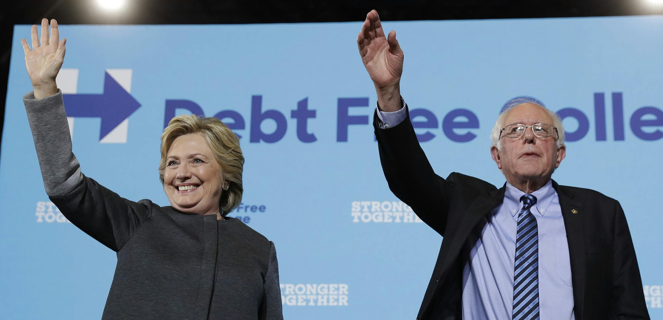 Democratic presidential candidate Hillary Clinton and Sen. Bernie Sanders, I-Vt. acknowledge the audience at a campaign stop at the University Of New Hampshire in Durham, N.H., Wednesday, Sept. 28, 2016. (AP Photo/Matt Rourke)