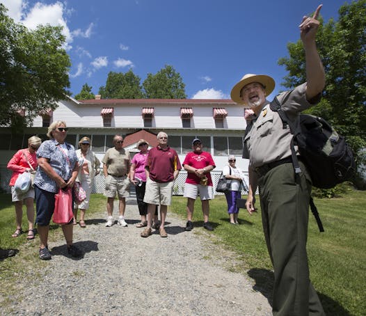 Kevin Nelson, an interpretive park ranger, leads a tour group at the Kettle Falls Hotel.