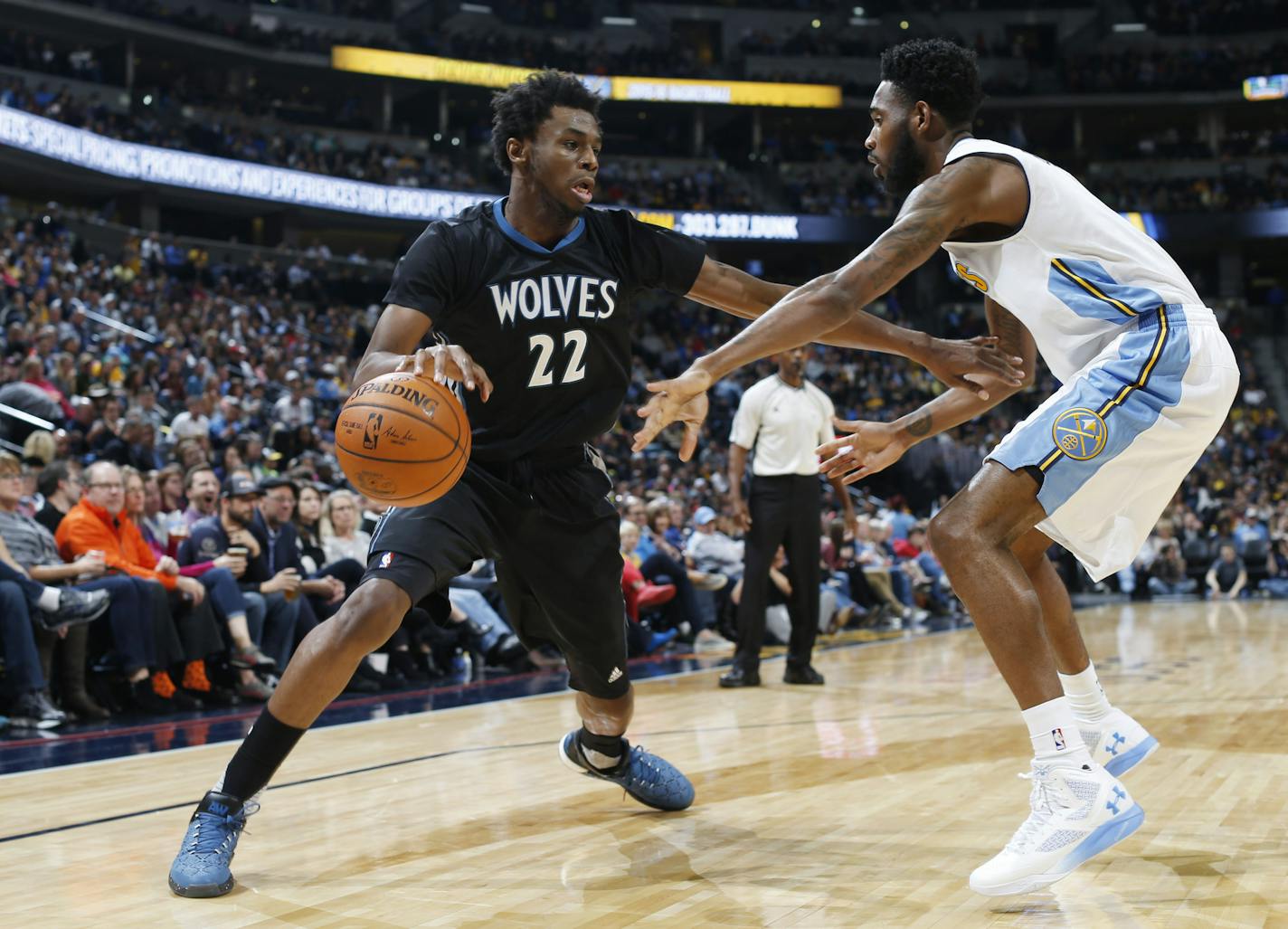 Timberwolves guard/forward Andrew Wiggins, left, drove for a shot as Nuggets guard Will Barton defended him.