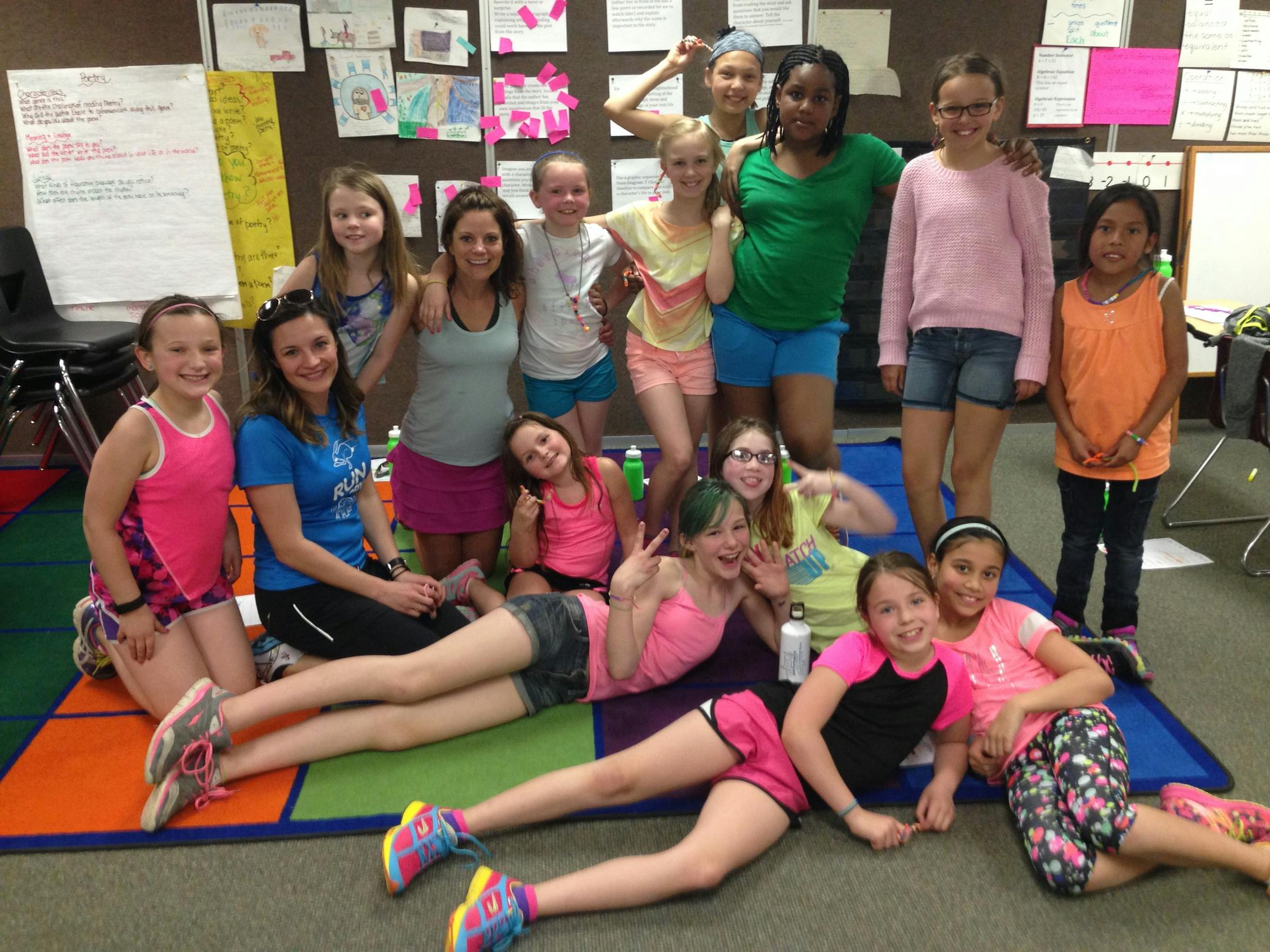 The 12 Girls on the Run participants at Greenleaf Elementary in Apple Valley pose for a photo in running clothes.