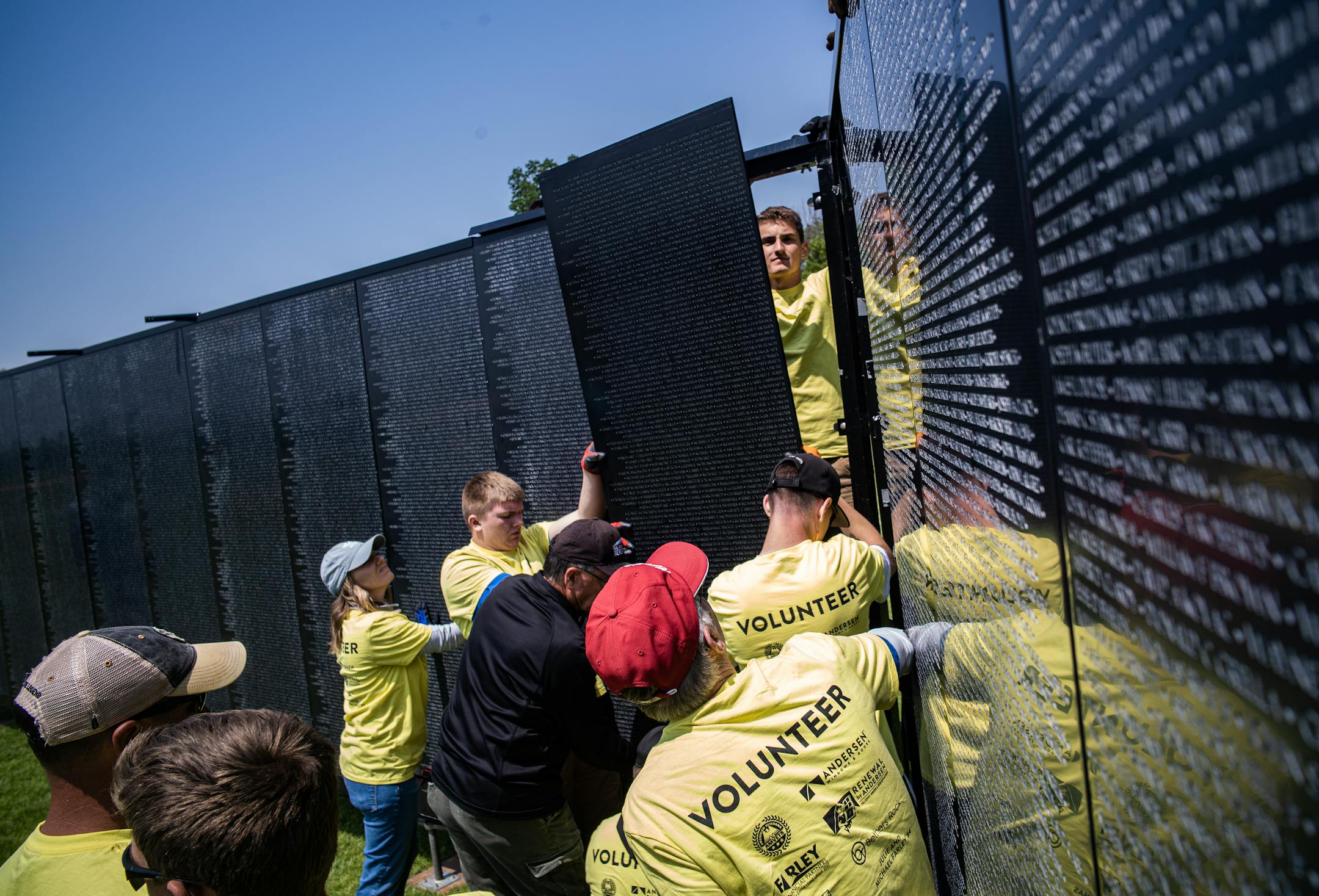 St. Thomas Academy cadets and volunteers help assemble a 3/4 scale of the Wall That Heals that contains 58,281 names of Vietnam Veterans who died.