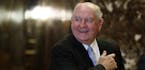 FILE- In this Nov. 30, 2016, file photo, former Georgia Gov. Sonny Perdue smiles as he waits for an elevator in the lobby of Trump Tower in New York. 