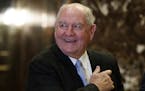 FILE- In this Nov. 30, 2016, file photo, former Georgia Gov. Sonny Perdue smiles as he waits for an elevator in the lobby of Trump Tower in New York. 