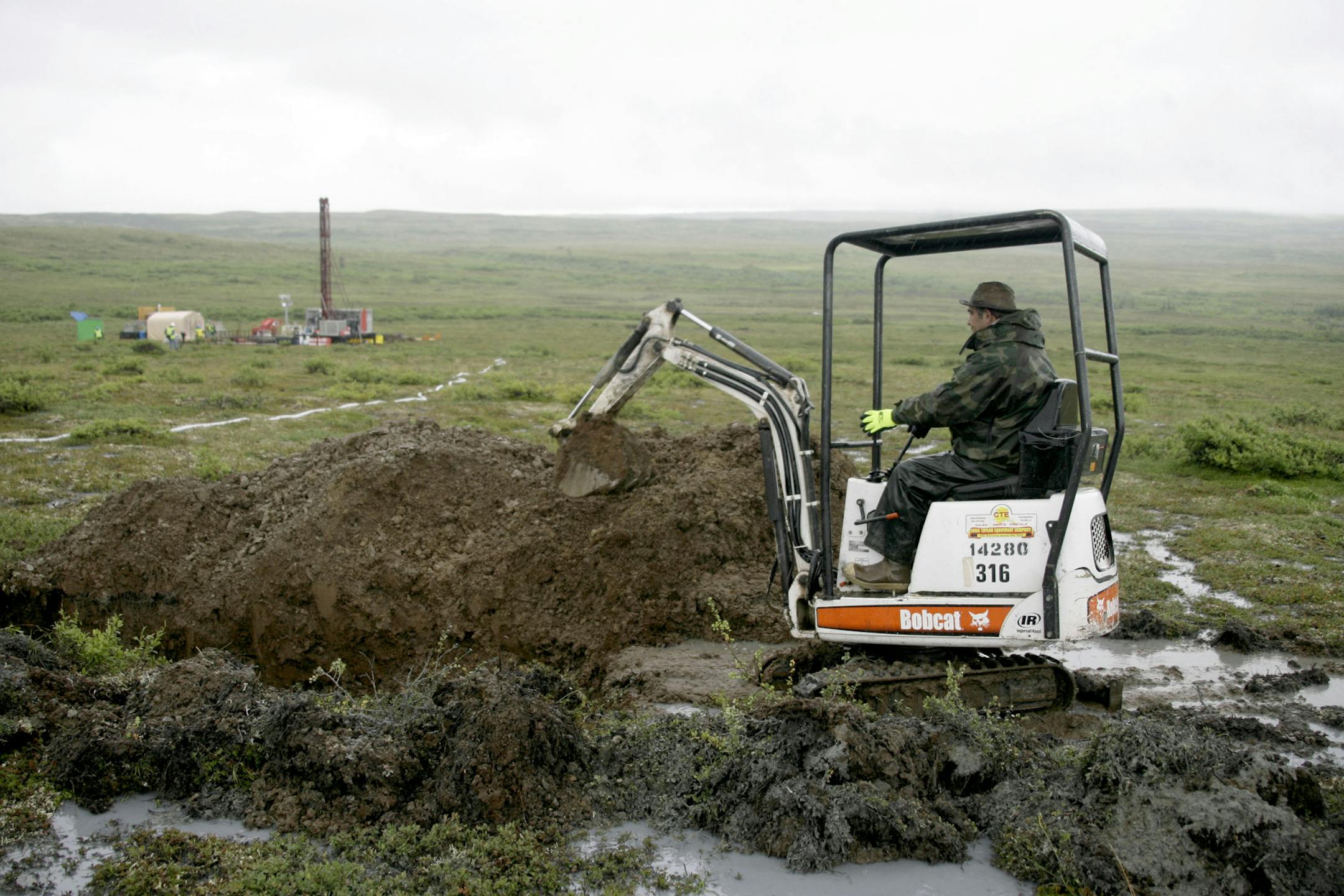 FILE- In this July 13, 2007 file photo, a worker with the Pebble Mine project test drills in the Bristol Bay region of Alaska near the village of Iliamma, Alaska. An EPA report indicates a large-scale copper and gold mine in Alaska's Bristol Bay region could have devastating effects on the world's largest sockeye salmon fishery and adversely affect Alaska Natives, whose culture is built around salmon.(AP Photo/Al Grillo,File)