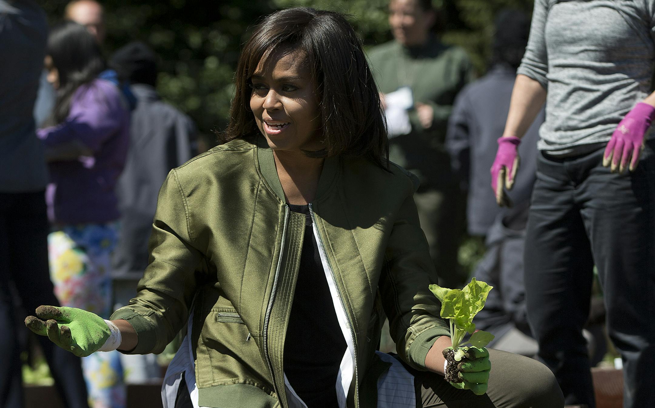 First lady Michelle Obama and NASA astronaut Cady Coleman plant vegetables during the eight annual White House Kitchen Garden planting on the South Lawn of the White House in Washington, Tuesday, April 5, 2016. (AP Photo/Pablo Martinez Monsivais) ORG XMIT: DCPM209