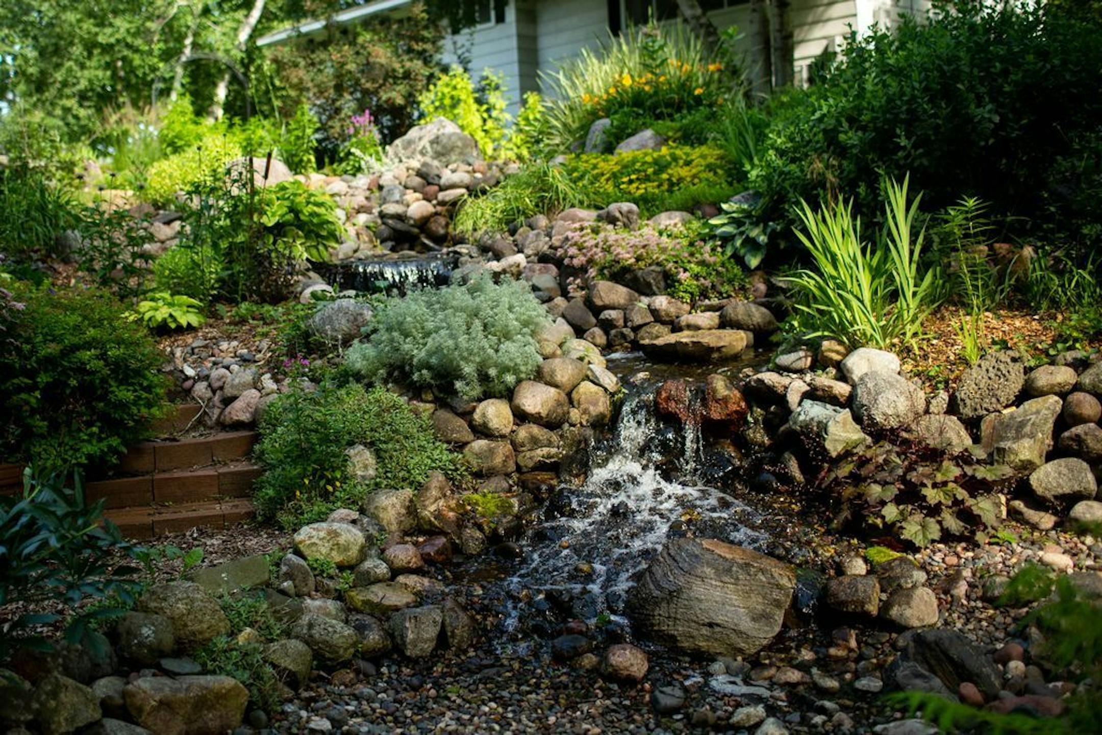 The bog is a natural filter in the pondless water feature, which uses an in-ground reservoir and pump at the bottom of the hill to recirculate the water.
