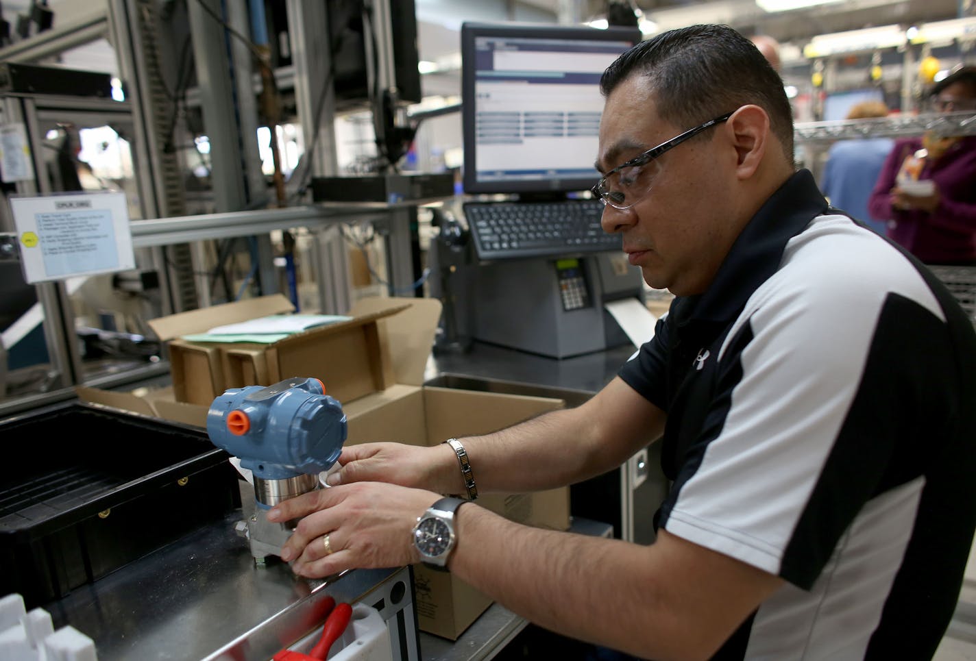 Raul Sedine does the final check on one of the custom made wired pressure gauges produced in Chanhassen . ] (KYNDELL HARKNESS/STAR TRIBUNE) kyndell.harkness@startribune.com Emerson Process Management in Chanhassen Min., Wednesday, October 15, 2014.